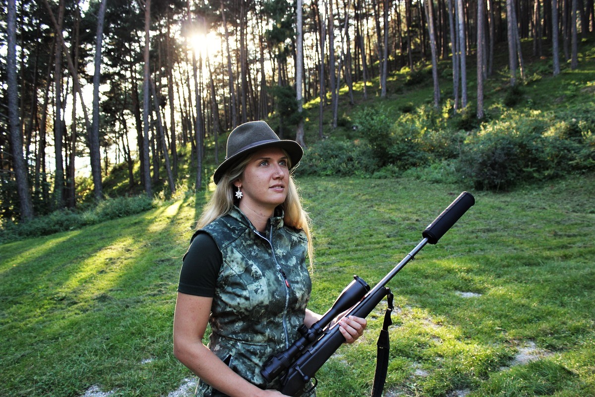 Jägerin mit Gewehr im Wald